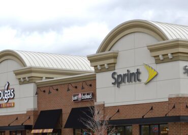 Sprint store exterior in a shopping plaza with nearby businesses.