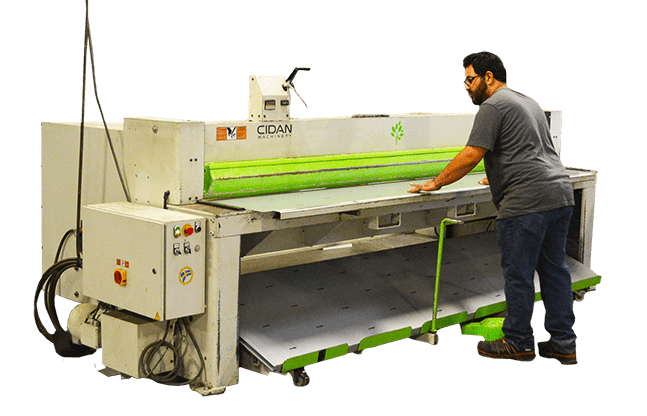 A man operating a large industrial printing machine.