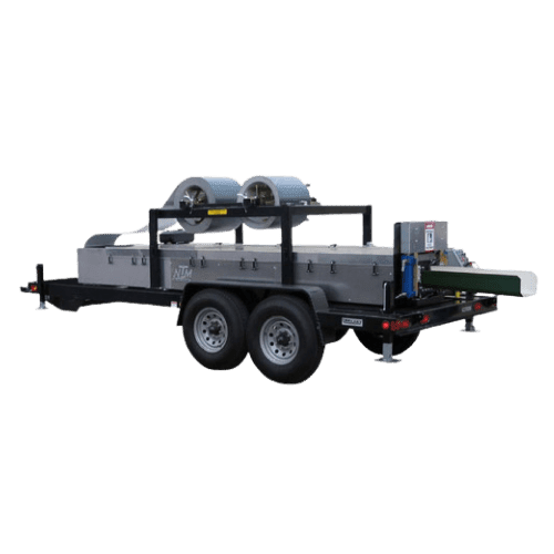 Mobile industrial machine on a dual-axle trailer.